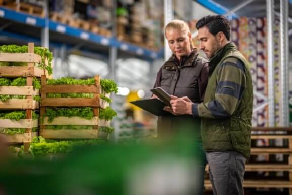 agknowledge people standing in produce warehouse